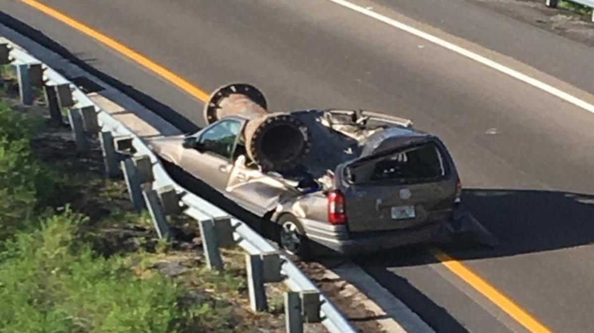 The driver of this van suffered minor injuries when a large piece of scrap metal fell on his vehicle from an overpass.