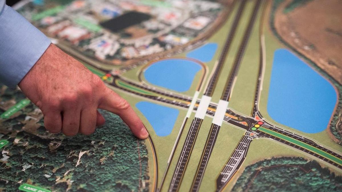 An official points to a map as locals gather for a public meeting to discuss Florida Department of Transportation's expansion about improvements planned for Interstate 75 at State Road 64 interchange at the RiverLife Church in Bradenton.