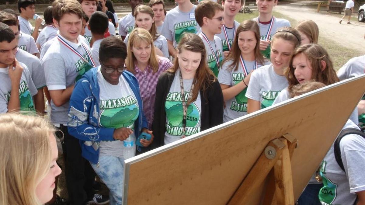 Envirothon teams study the scoreboard during the competition at Oscar Scherer State Park in 2014.