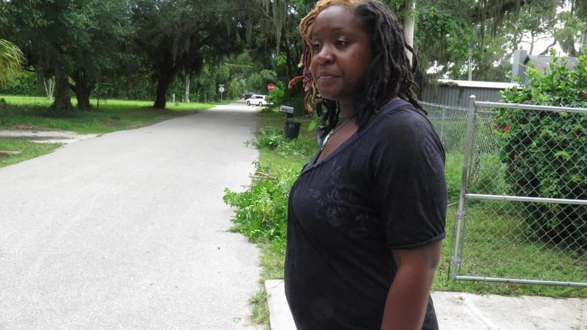 Taura Denis, 36, stands outside her Samoset home Monday evening. Denis and her husband, Dimitrie Denis, are leading efforts to petition for the installment of street lighting in the community.