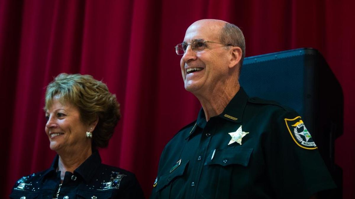 Manatee County Sheriff Brad Steube laughs with his wife, Debbie, before receiving a gift from the community as supporters gather for a tribute to the outgoing sheriff during his final “Supper with the Sheriff” dinner at the cafeteria in the Police Athletic League building on Thursday evening. Over 200 friends, coworkers and community members shared memories of Steube at the event before discussing community issues.