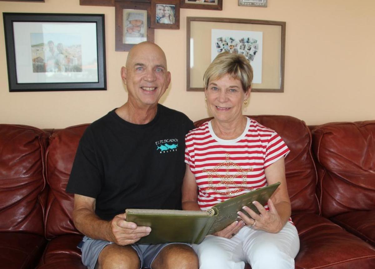 John and Diane Tucker look through one of her photo albums from the Vietnam War.