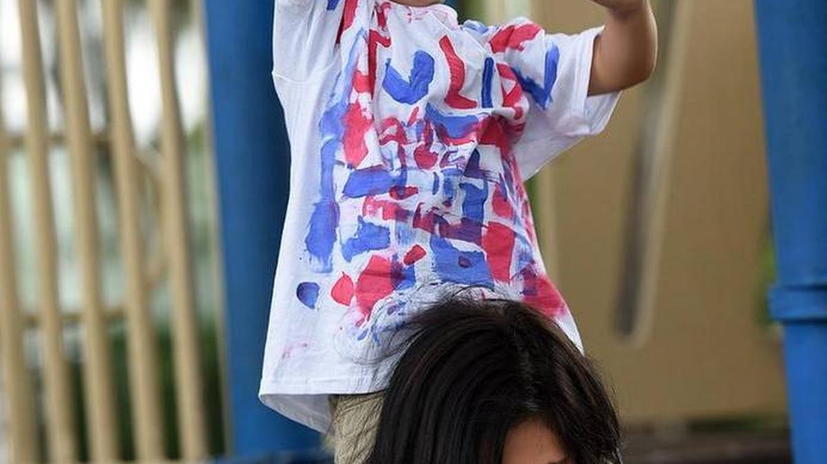 Kaekoa Gill, 14, plays with cousin Julain Alejandre, 3, at Sutton Park during this past Fourth of July Festival. Bradenton Herald file photo