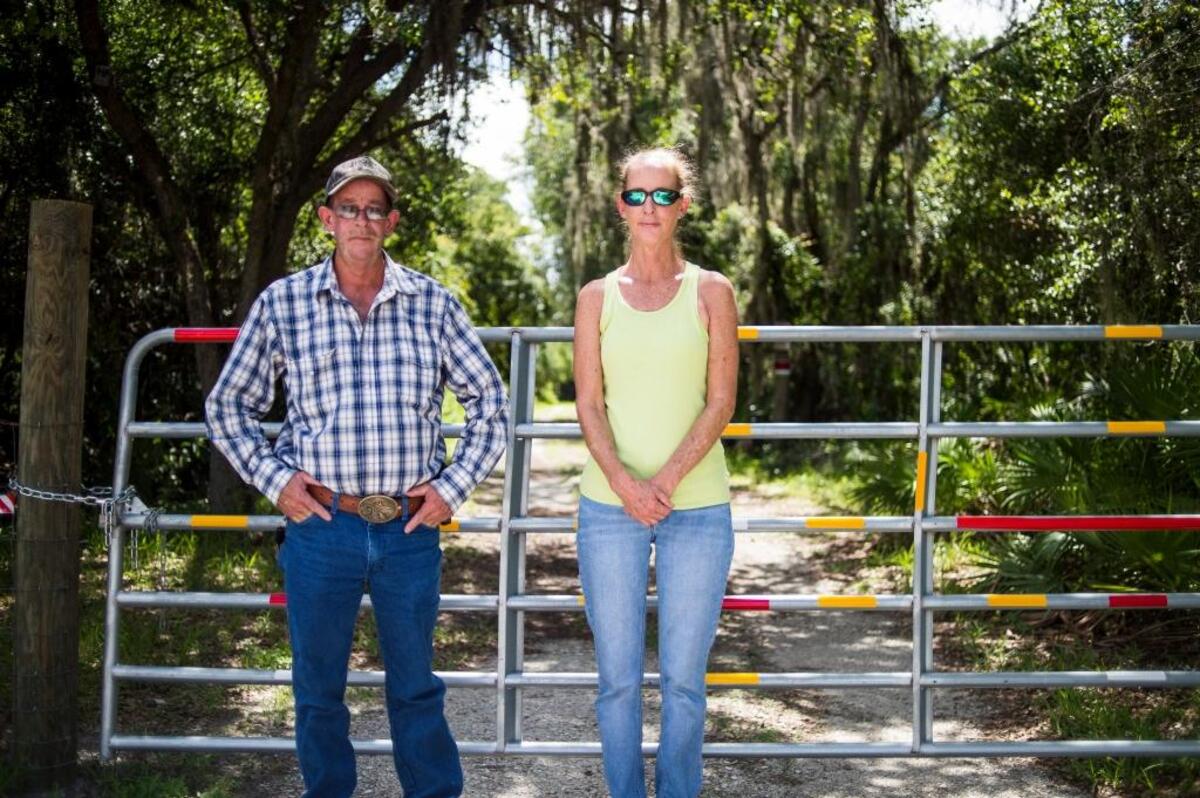 Diana and Phil Bergstresser pose for a portrait outside of their brother, Carl's, property on June 22, 2017 in East Bradenton. The two siblings have been fighting to keep their late brother's property out of the hands of developers, and keep it as a nature preserve as they say he intended.