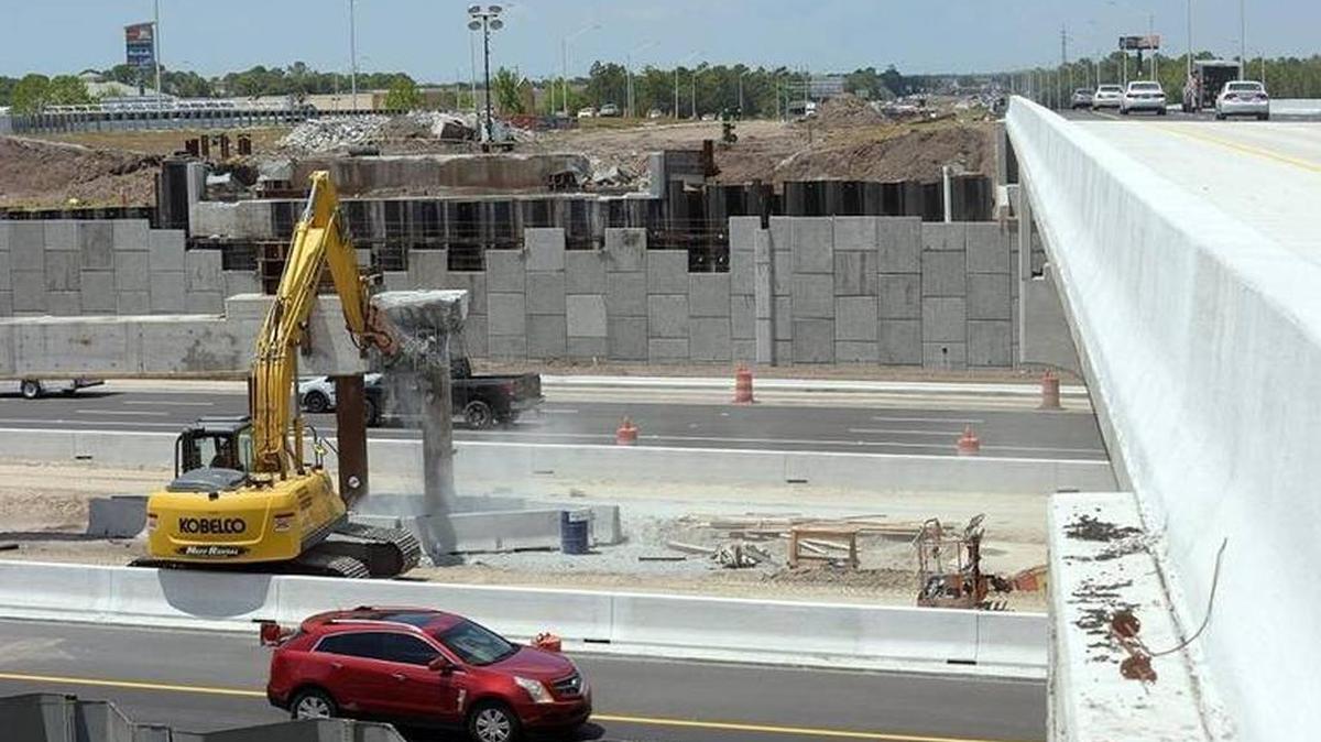 Heavy machinery works to take down a support beam for the temporary Acrow bridge which was used as the permanent ones were under construction over University Blvd at I-75. The diverging diamond interchange, under construction, will be the largest of its kind in the U.S. when complete. The DDI traffic pattern is expected to be implemented early June.