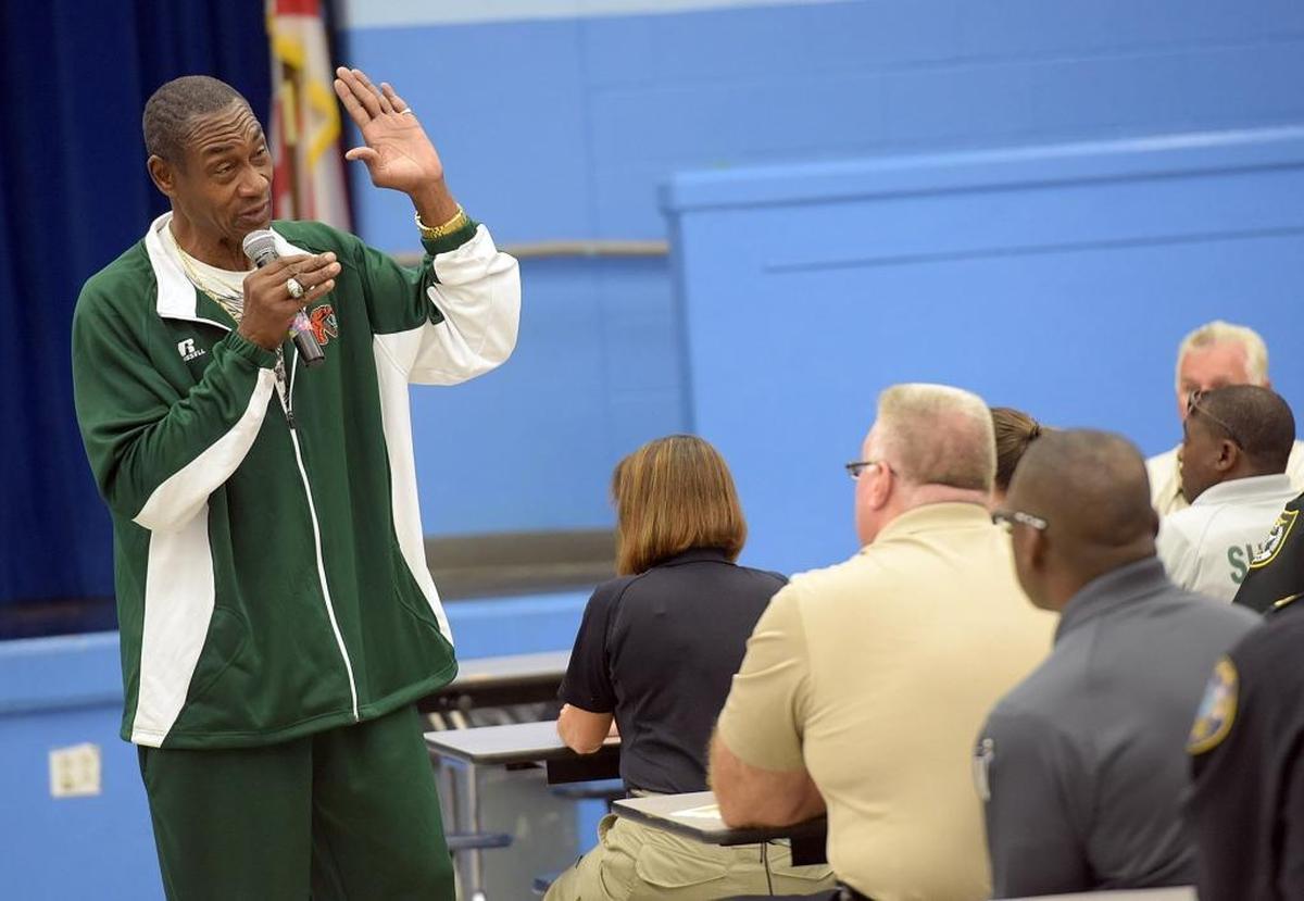 Ray Bellamy addresses a crowd gathered at Lincoln Middle School on Wednesday as the Manatee County Sheriff’s Office helped pack and distribute 150 Thanksgiving baskets for the first Sylvester Bellamy Thanksgiving Drive.