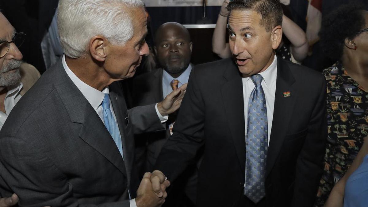 In this file photo, Former Florida Gov. Charlie Crist, left, shakes hands with St. Petersburg, Fla., Mayor Rick Kriseman after Crist was elected to the U.S. House of Representatives Nov. 8 in St. Pete Beach.