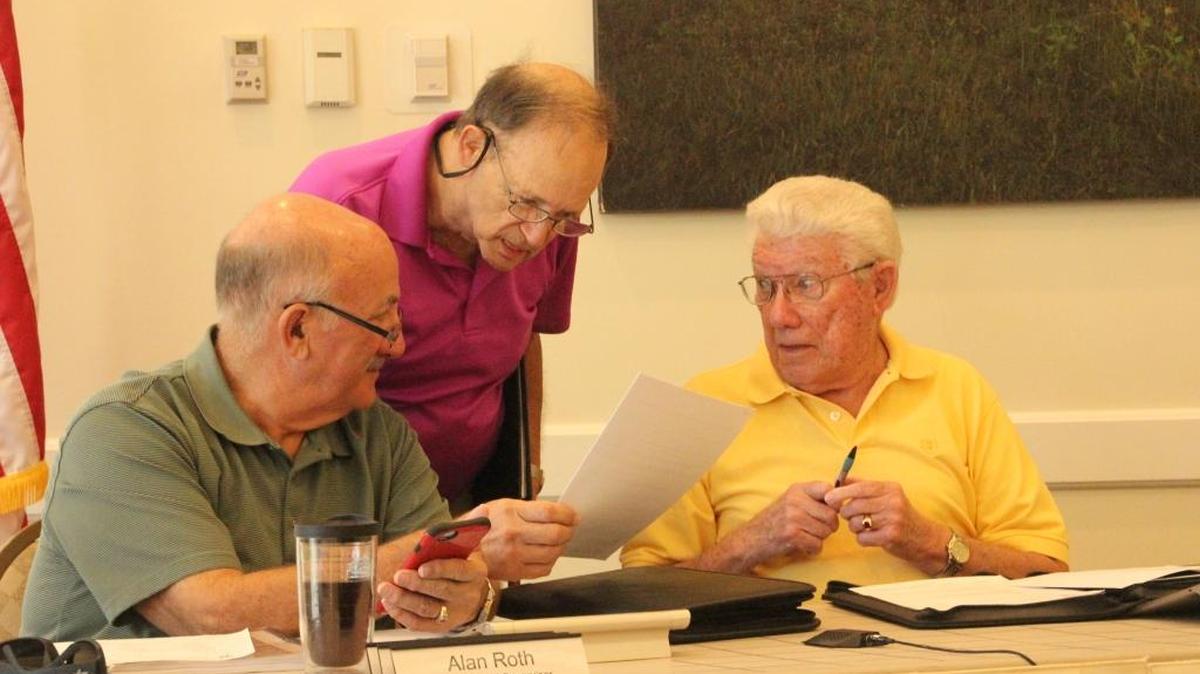 Gary Berns, standing, alerted Lakewood Ranch supervisors to American Medical Association guidelines on blue lighting in LED lamps. Also shown are Alan Roth and Gilbert Pearce.