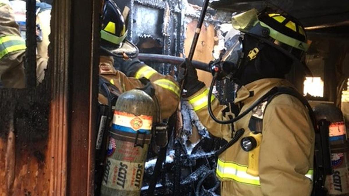 Firefighters work inside a mobile home in the WT Mobile Home Park in Bradenton that was destroyed Tuesday afternoon.