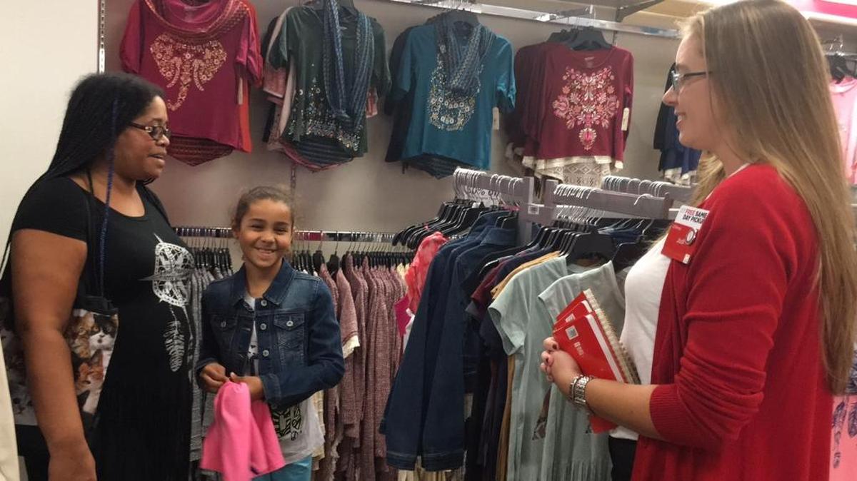 Chanta Bussell, left, and her daughter, Mia, 9, chat with new JC Penney store manager Jodi Rice, right. The Bussells, like many shoppers Sunday, took advantage of the last day of the back-to-school tax holiday to get some good deals at the DeSoto Square Mall.