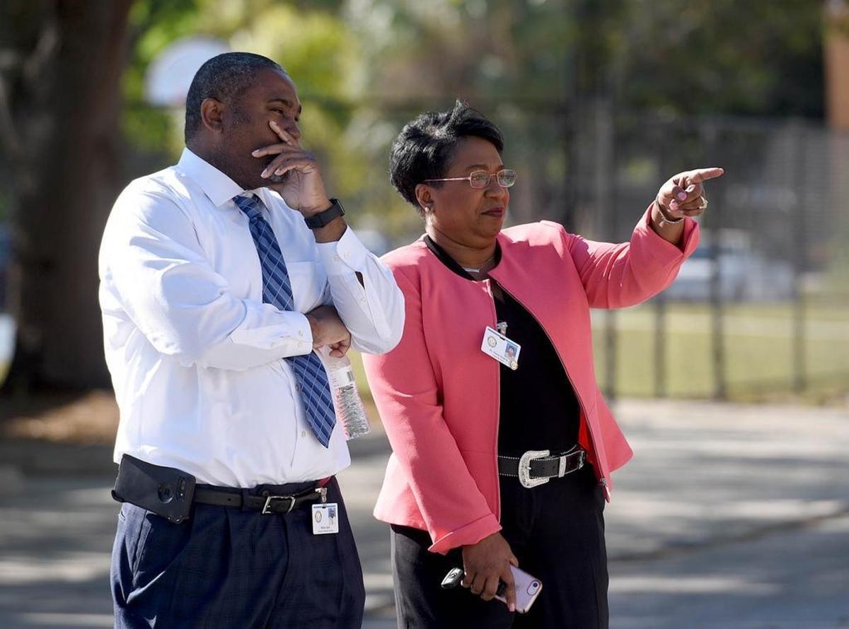Manatee School superintendent Diana Greene, right, points to a large group as Manatee High School students walked out of class on Wednesday at 10 a.m. for 17 minutes to remember those killed in the Parkland shooting.