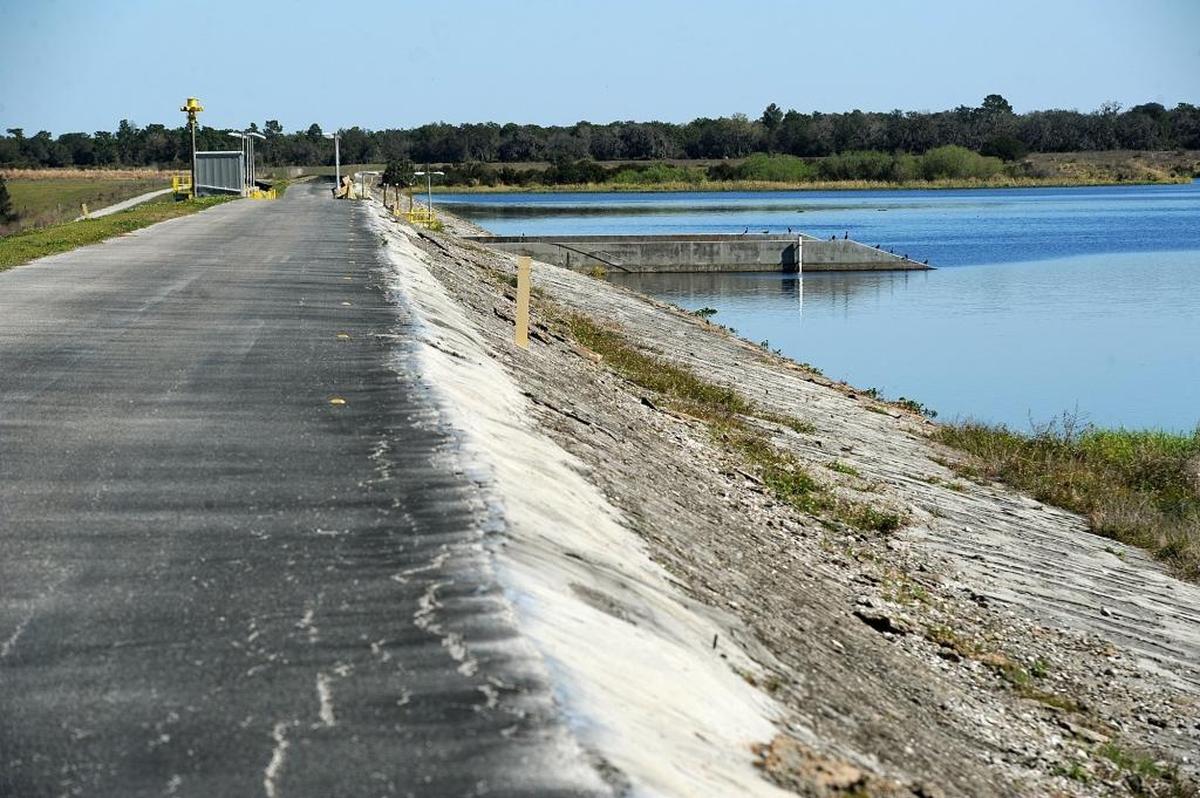 Officials are continuing to slowly lower water levels at the Lake Manatee dam as engineers investigate the integrity of the walls and the clay core of the dam, which they warned could be compromised by heavy rains. Shown is an access road which goes over the spillway.