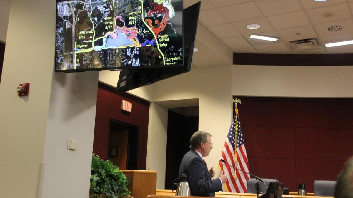 Richard Bedford, vice president of planning for Schroeder-Manatee Ranch, talks to Sarasota County commissioners about a proposed I-75 overpass that would connect Lakewood Ranch Boulevard and Cattlemen Road. SMR is working on design and permitting of the overpass. An overhead TV screen shows a network of road improvements extending Lakewood Ranch Boulevard and Lorraine Road into Sarasota County, as well as the proposed location of the overpass.