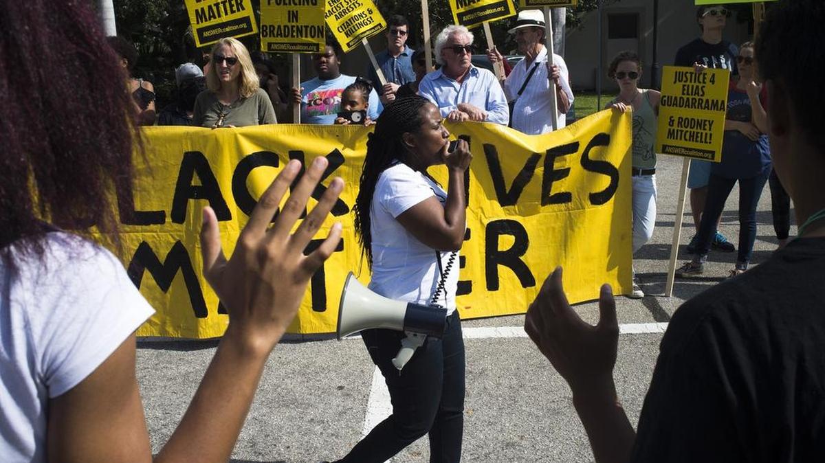 Ruth Beltran, a community organizer for Black Lives Matter and the ANSWER Coalition, shouts into a megaphone during a protest against alleged discrimination from Bradenton Police outside the Bradenton City Police Department on Saturday morning in downtown Bradenton.