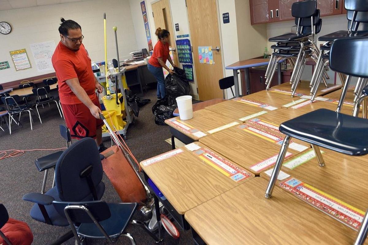 David Robles and Marcellus Ibarra clean a classroom at Prine Elementary School, which was used as an evacuation shelter Tuesday after Hurricane Irma.