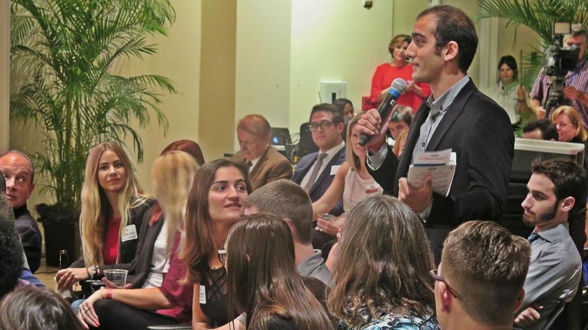 Ozan Gokdemir questions local business leaders about how graduates may obtain money toward starting a new business in the area.