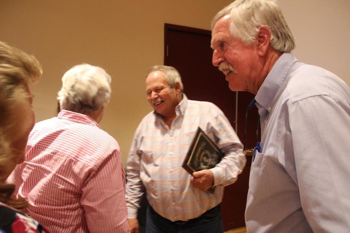 This year’s Outstanding Agriculturist, Mitchell John, center, was congratulated by previous recipients Priscilla Whisenant Trace and Hugh Taylor.