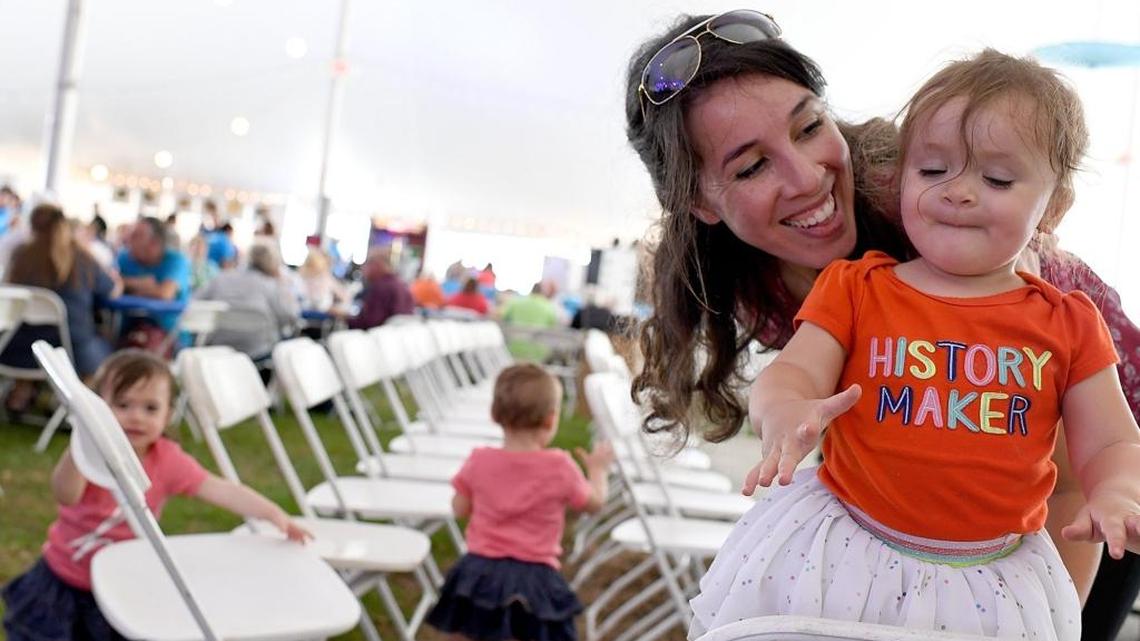 Cici Mouici and her daughter, Layla, 17 months, enjoy the music at the 34th annual Greek Glendi at St. Barbara Greek Orthodox Church in East Manatee Friday. The festival continues through the weekend.