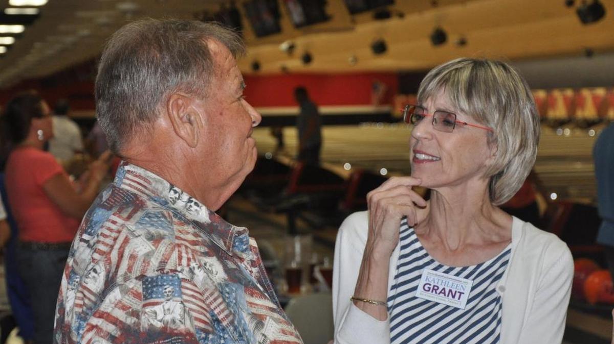 Chester Bullock, who is running for Manatee County property appraiser, and Kathleen Grant, who is running for county commissioner, visit during Bowling with the Candidates event Thursday at Cortez Lanes in Bradenton.