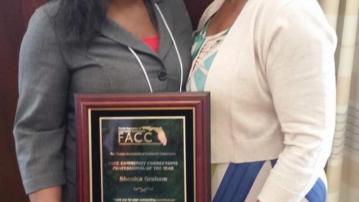 Shenica Graham, a Manatee County probation officer, receives the Florida Community Corrections Professional of the Year award with her mother, Judy Smith.