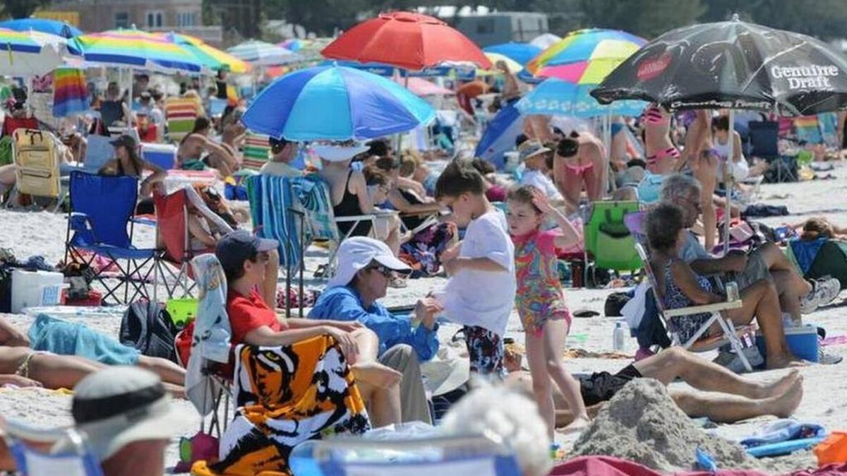 People enjoy the sun and sand at Manatee County Public Beach. Manatee County Marine Rescue lifeguards watched over 2.7 million visitors last year.