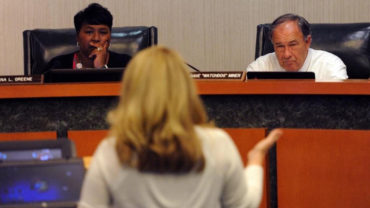 Superintendent Diana Greene and Manatee County School Board member Dave Miner listen to Amy Lee as she addresses the student progression plan during public comments at a workshop Monday at the School Support Center in Bradenton.