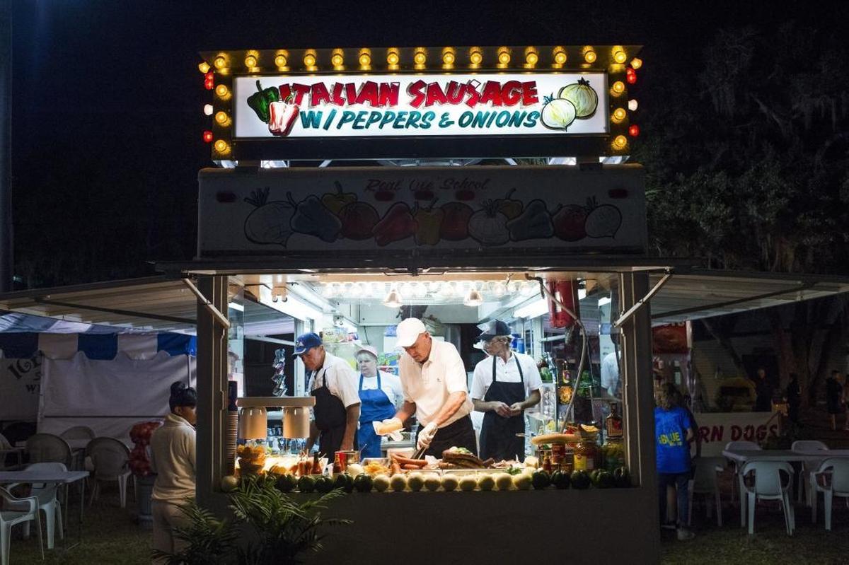 Employees at the Italian Sausage food truck serve food during opening night of the Manatee County Fair in 2017 at the Manatee County Fairgrounds in Palmetto.