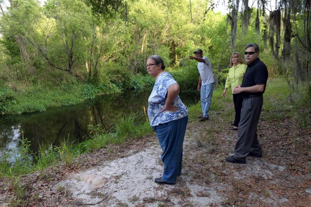 Braden Woods residents Mary and Gary Hebert, Carl Bergstresser and Brenda Russell walk along the Braden River on Carl's property, marveling at the beauty of the area. The group are part of a larger group who are opposed to a proposed new development.