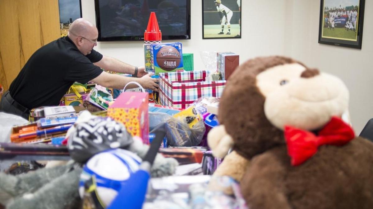Brian Commo stacks toys into a pile as the Bradenton Marauders host Marty’s Toy Drive on Saturday morning at Pirate City in Bradenton. New, unwrapped toys are collected and donated to the Salvation Army for distribution to children in need in Manatee County.