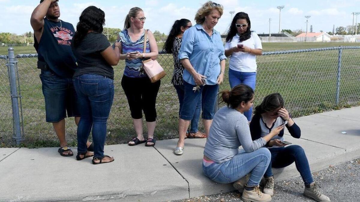 Parents gather outside the school as they wait to hear about the lockdown at Bayshore High on Feb. 22, 2018.