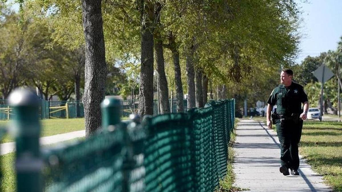 Manatee County Deputy Kenny Cristello walks the perimeter of Prine Elementary School Monday morning as more school resource officers are deployed at county schools.