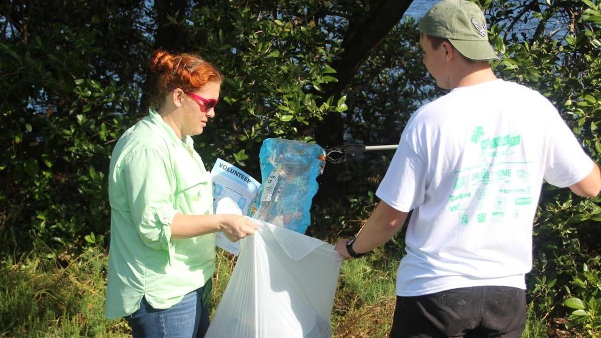 Stephanie Phillips and her son, Aengus, cleaned up trash at Kingfish boat ramp for the International Coastal Cleanup on Saturday.