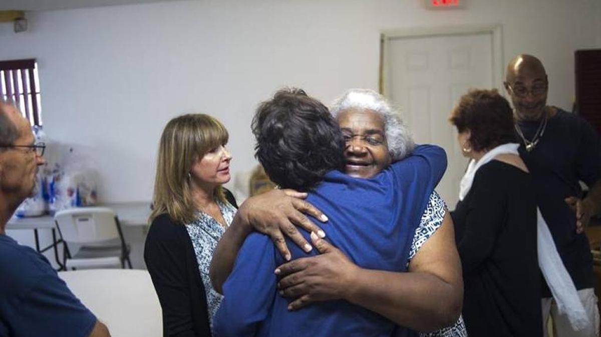 May Lizzie Jennings hugs those who attended the community’s first Washington Park meeting in July as a growing group of residents and outside partners join forces in an effort to clean up and make safe the East Bradenton neighborhood.