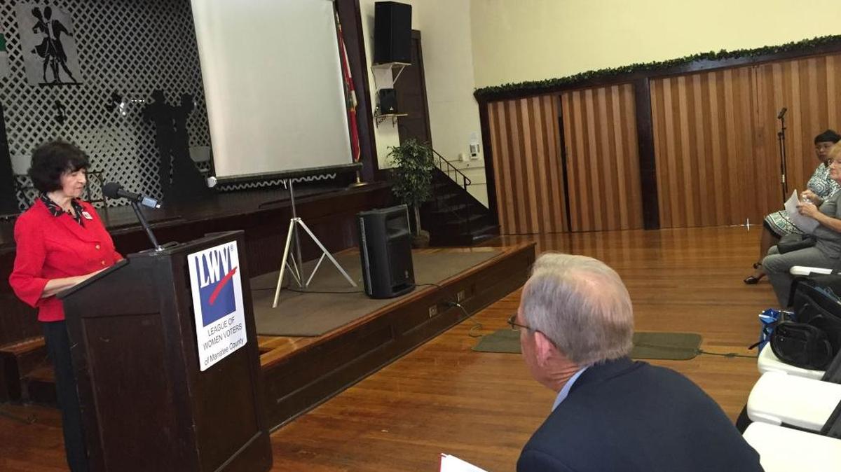 Rosalie Shaffer, president of the League of Women Voters, welcomes members of the public to an event debating the pros and cons of the two half-cent sales tax initiatives on the November ballot.