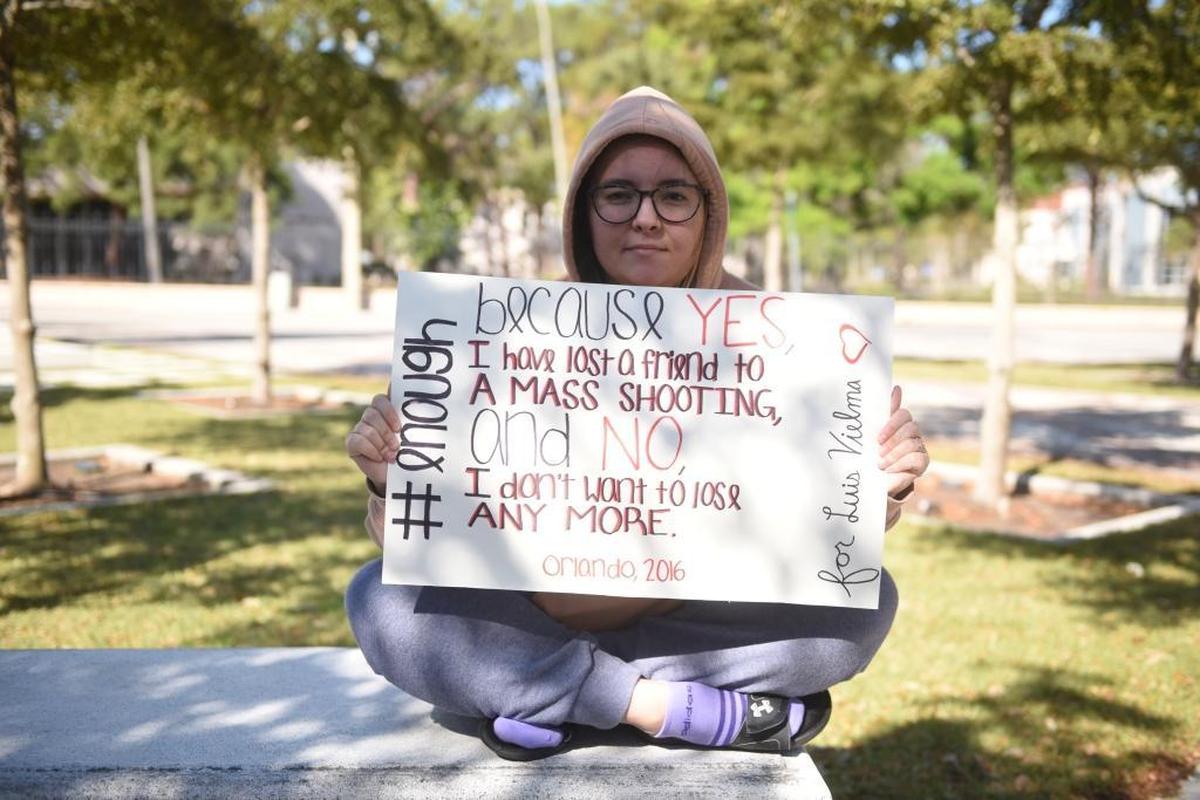 Chelsea Torregrosa, 22, holds a sign Wednesday to honor her late friend Luis Vielma, who was one of the 49 victims of the Pulse nightclub shooting. Torregrosa was one of about 300 who participated in New College of Florida’s walk-out event to protest gun violence after 17 were killed at Marjory Stoneman Douglas High School in Parkland, Fla. on Feb. 14.