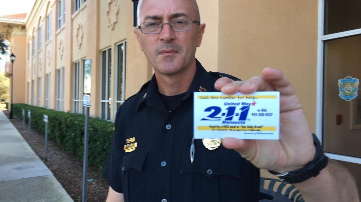 Bradenton Police Department Captain William Fowler holds up "the 211 card" that is at the center of a new program being rolled out in Manatee County to reduce panhandling. The 211 call puts people in touch with services they may need to improve their lives through a social service hotline for Manatee and Sarasota.