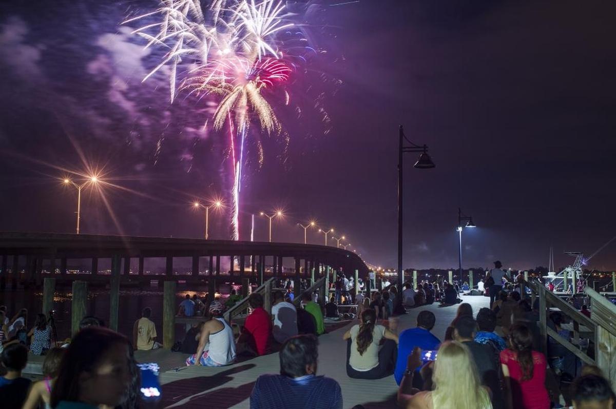 Fireworks explode overhead spectators during an Independence Day fireworks show on July 4, 2017 over the Manatee River in Bradenton.
