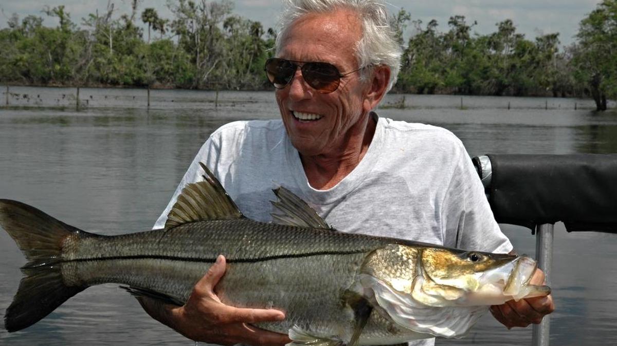 FWC biologist Ron Taylor holds a snook that was caught and later released as part of a research project.