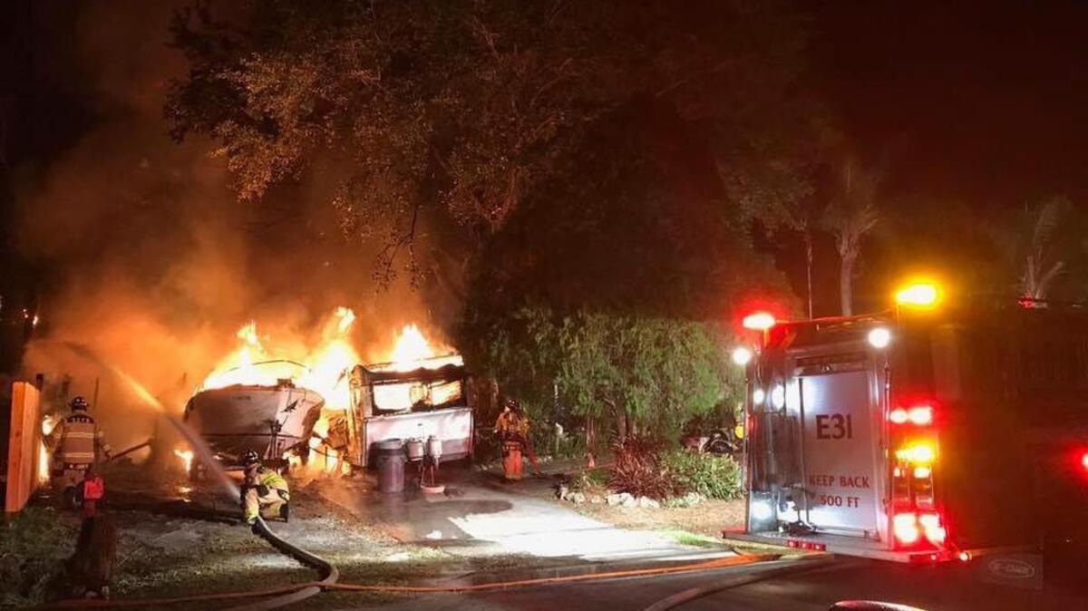 A house, camper and boat caught fire early Wednesday in Sarasota.