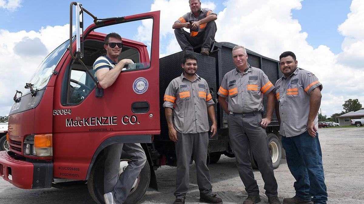 Ian Schneider, left, and employees Rich Imes, top, Chris Whiddon, Mark Sartin and Rafael Rodriguez, of E.T. McKenzie Co., went around with company trucks and cleaned up trees and debris after Hurricane Irma.