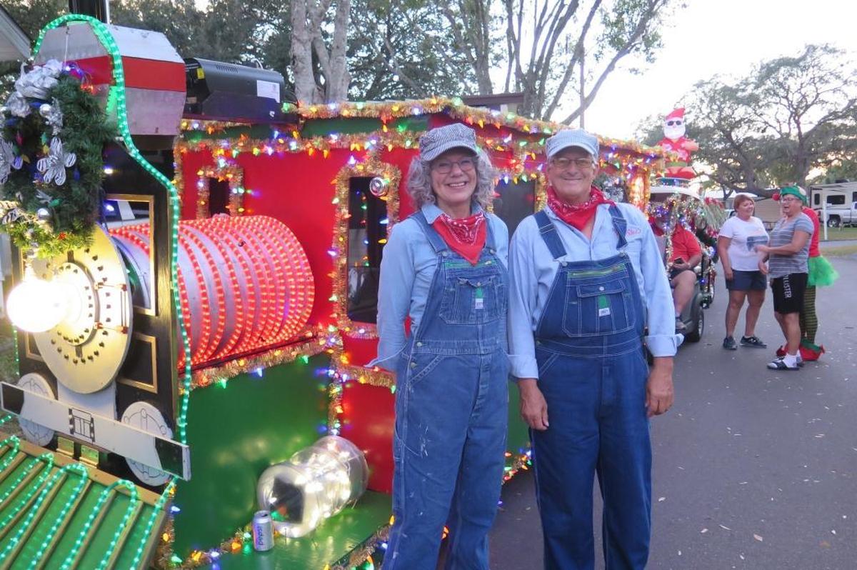 Patti Barrett (left) and Buddy Bunson get ready to jump on their cart-turned choo-choo train at Horseshoe RV Resort’s 19th Annual Golf Cart Parade on Monday, Dec. 18.