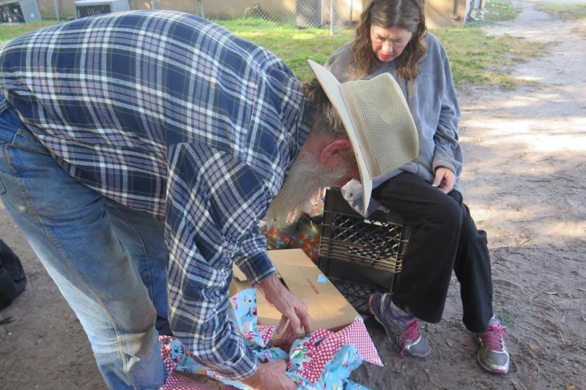 Roy Harris, 66, a Vietnam veteran, opens a present delivered by students from Electa Lee Middle School on his birthday, Friday, Dec. 22.