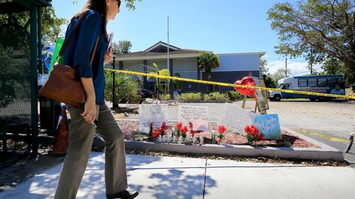 Dawn Schonwetter stops to look at a memorial of flowers and messages left on the sidewalk of the Rehabilitation Center of Hollywood Hills on Saturday, September 16, 2017. Eight people died at the nursing home in the aftermath of Hurricane Irma.