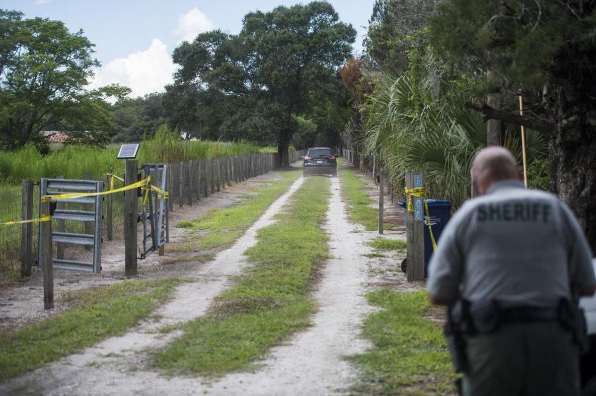 Medical examiners drive down the road towards the east Manatee County home where 54-year-old Dwayne Hutchinson was killed during a home invasion early Saturday morning, according to Manatee County Sheriff's Office.