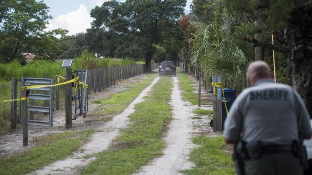 Medical examiners drive down the road toward the east Manatee County home where a Dwayne Larry Hutchinson, 54, was killed during a home invasion early Saturday morning, according to Manatee County Sheriff’s Office.