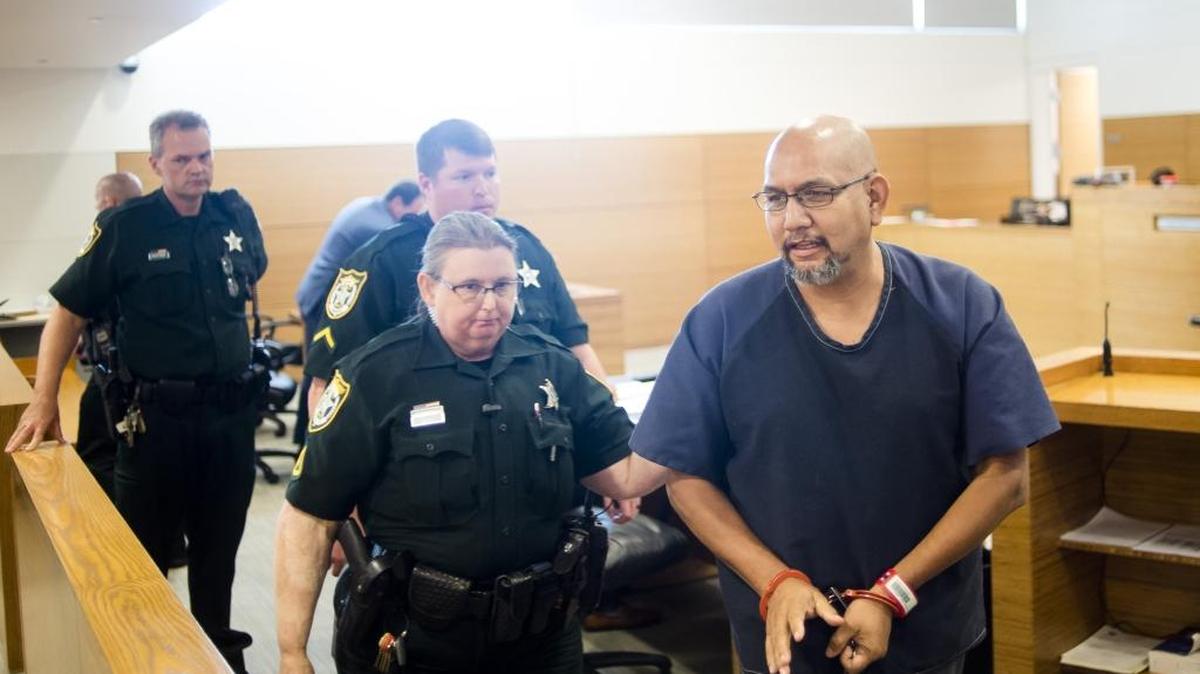 Juan Gomez, a former Wimauma pastor convicted of sexually battering a teenage boy, is taken away in handcuffs after being sentenced to 18 years in prison and 10 years of sexual predator probation on Friday afternoon at the Manatee County Courthouse in downtown Bradenton.