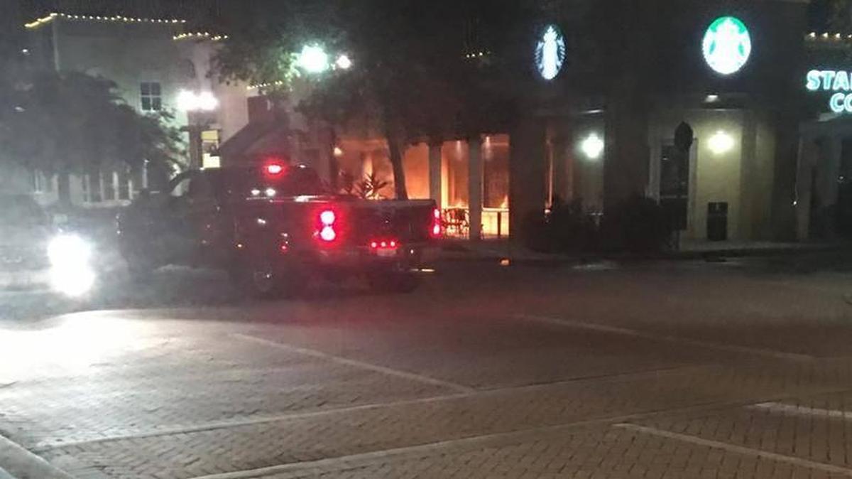Flames can be seen on the patio of the Starbucks at 8155 Main Street, Lakewood Ranch on Saturday night. Firefighters quickly put out the blaze which occurred shortly after 11 p.m. when the store was closed.