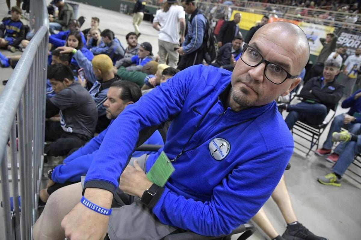 South Dade principal Javier Perez shows his wrist band while watching one of the school's championship matches earlier this year. Perez lost his legs when a suspected drunk driver plowed into him in at a baseball field.
