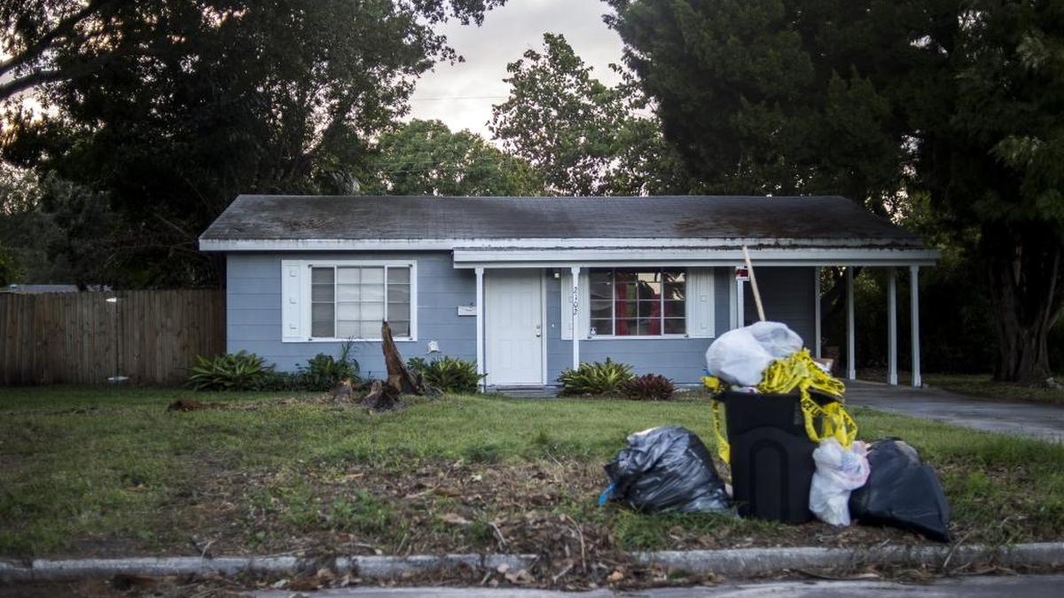 Police tape is seen in the trash at the house at 2102 21st Street West, the scene of Sunday's homicide, on Thursday afternoon in Bradenton.