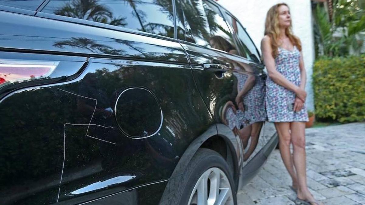 Kim Rosenfeld stands near her car that was vandalized on Prairie Avenue in Miami Beach on Sunday.